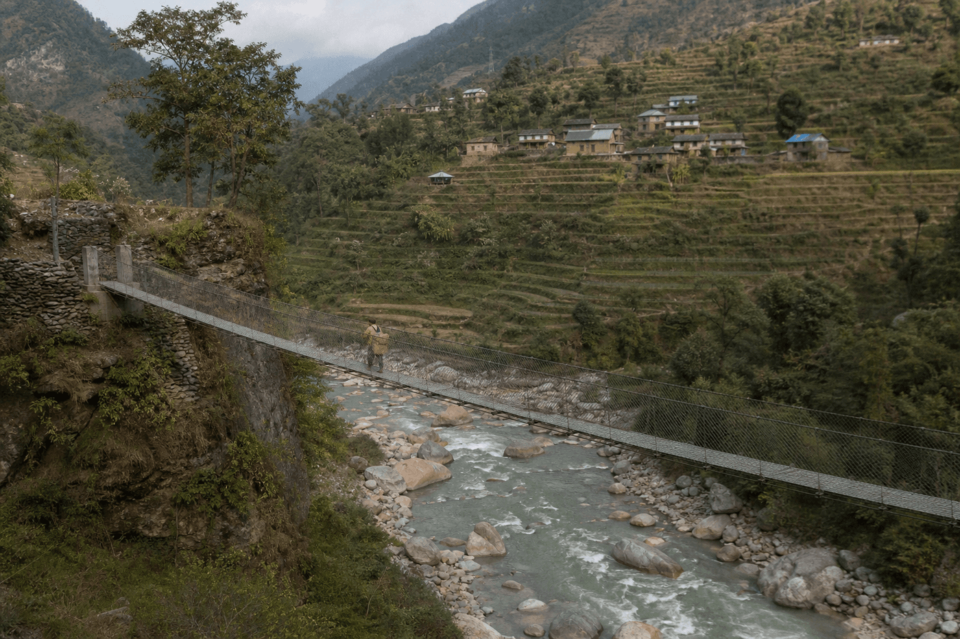 A steel footbridge spanning a river gorge in the Sanjala Valley
